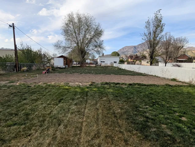 Fenced backyard with a storage shed