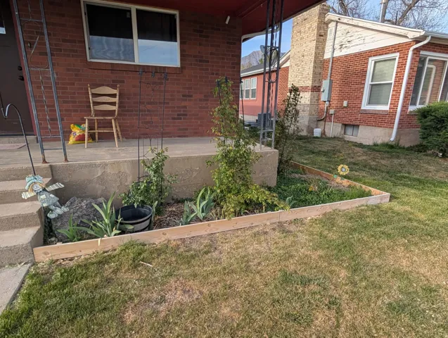 Exterior space featuring a yard and brick siding