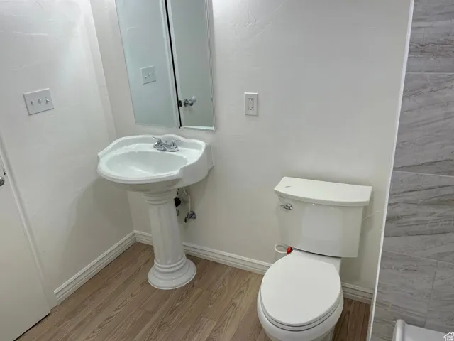 Bathroom featuring light wood finished floors and toilet