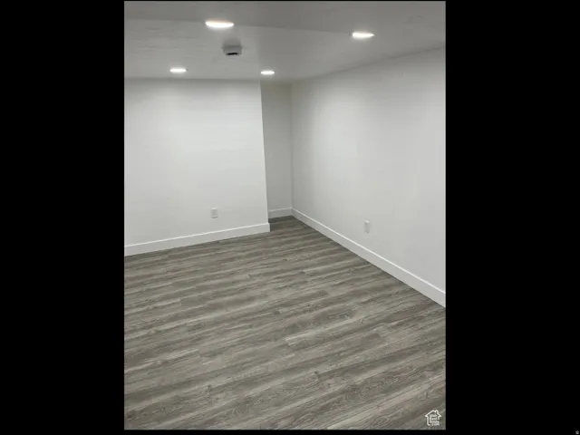 Spare room with wood finished floors and recessed lighting