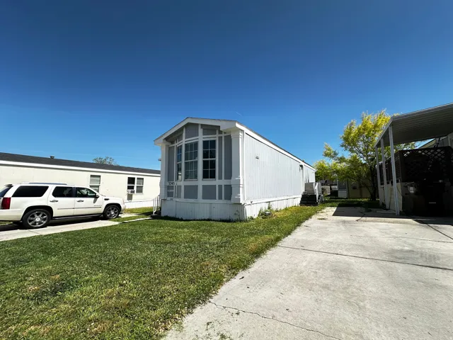 View of home's exterior with a yard