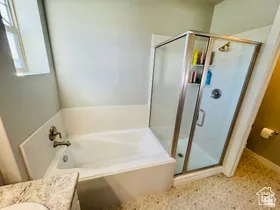Primary Bathroom with vanity, a shower stall, and a bath