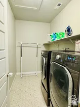 Laundry room with washing machine and dryer and baseboards