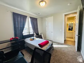 Bedroom TWO featuring light carpet and baseboards