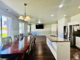 Dining room with dark wood finished floors and a textured ceiling
