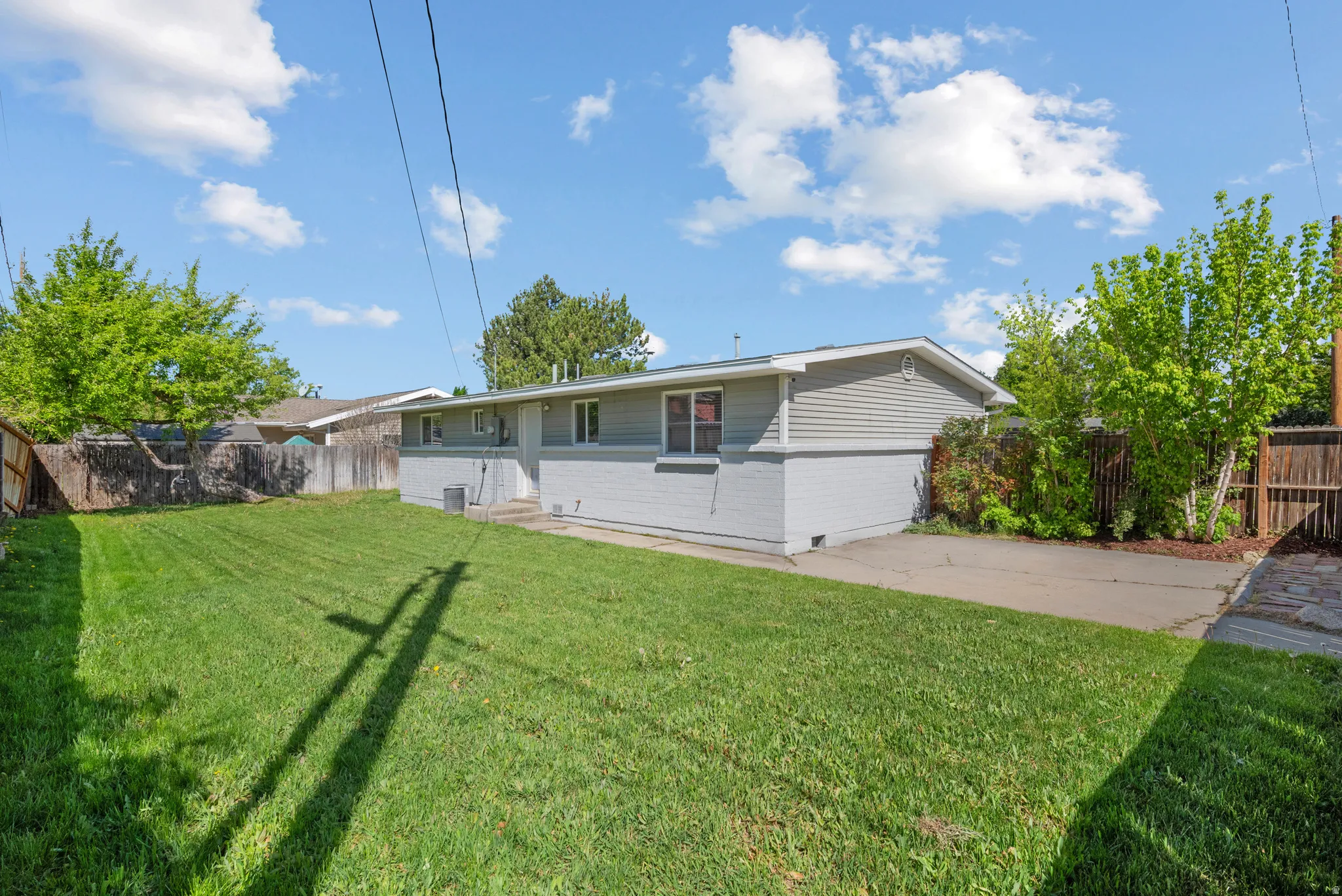 Back of property with a fenced backyard