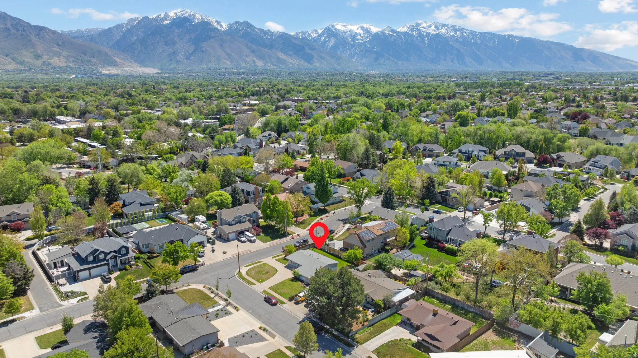 Aerial perspective of suburban area with a mountainous background