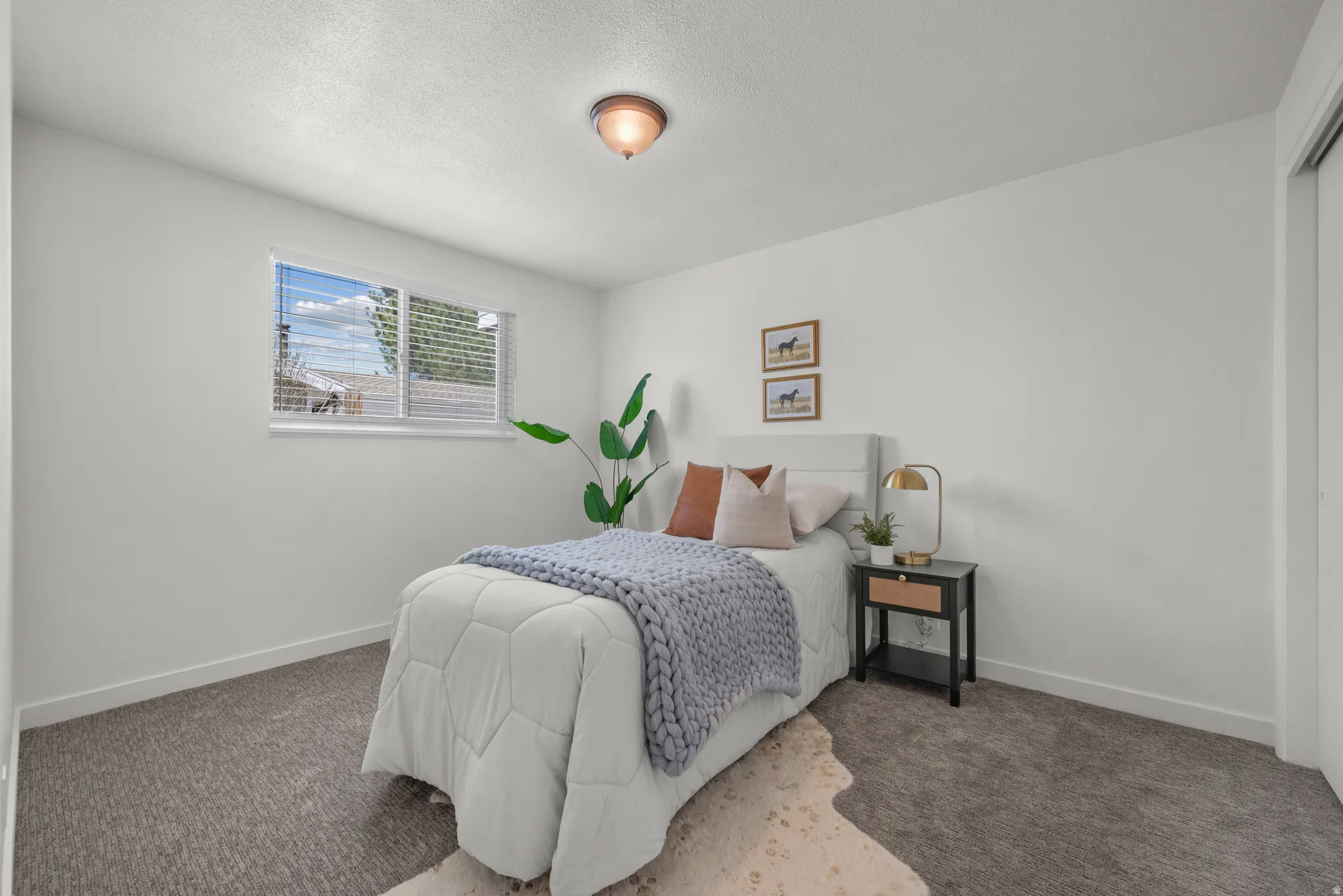 Carpeted bedroom featuring baseboards