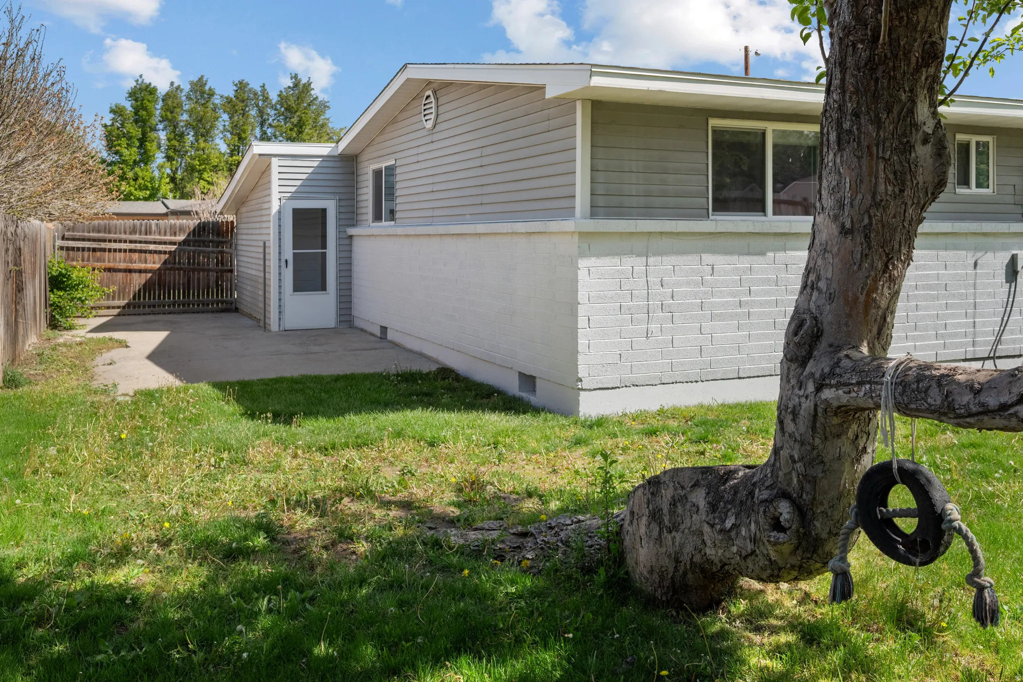View of side of home featuring a fenced backyard, crawl space, a patio, and brick siding