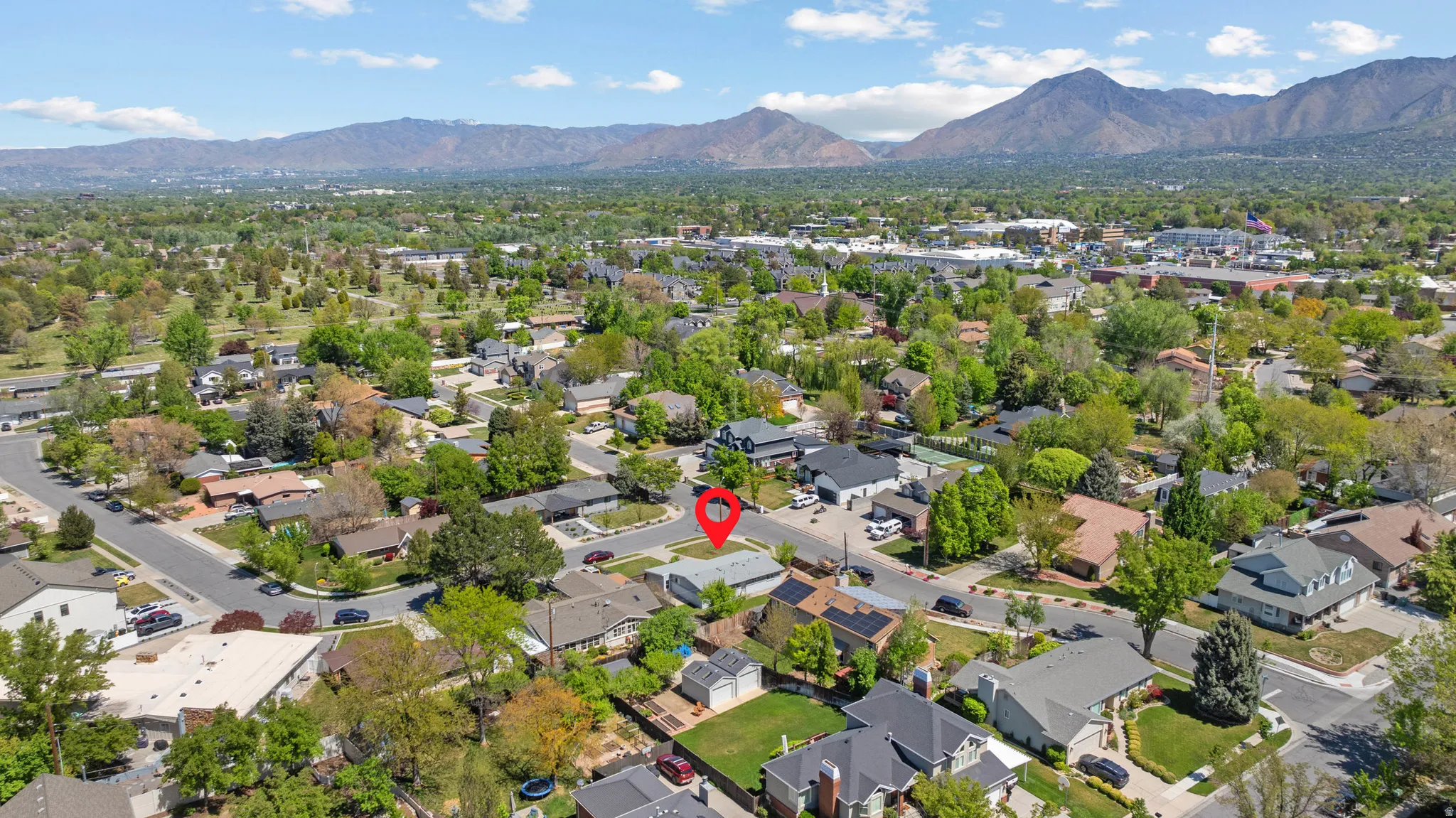 Aerial perspective of suburban area featuring a mountainous background