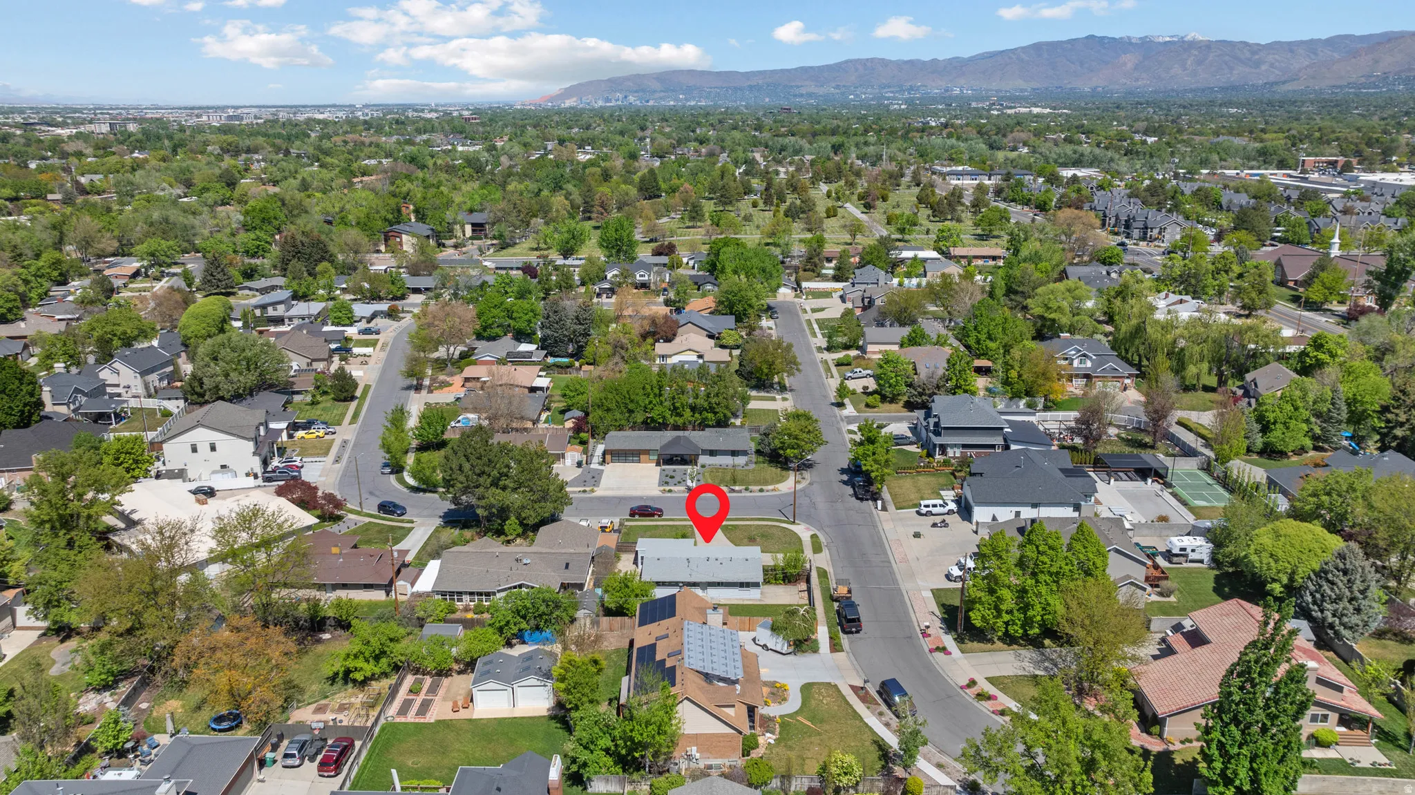 Aerial view of residential area featuring a mountain backdrop