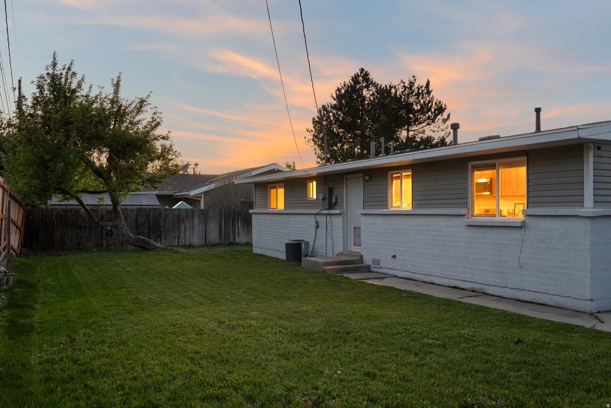 Back of property featuring entry steps and brick siding
