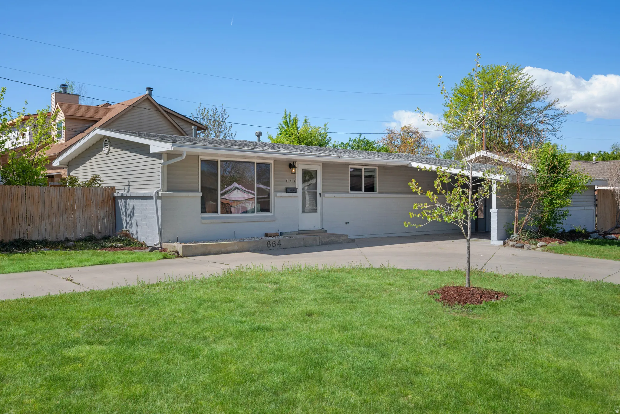Ranch-style home with brick siding and concrete driveway