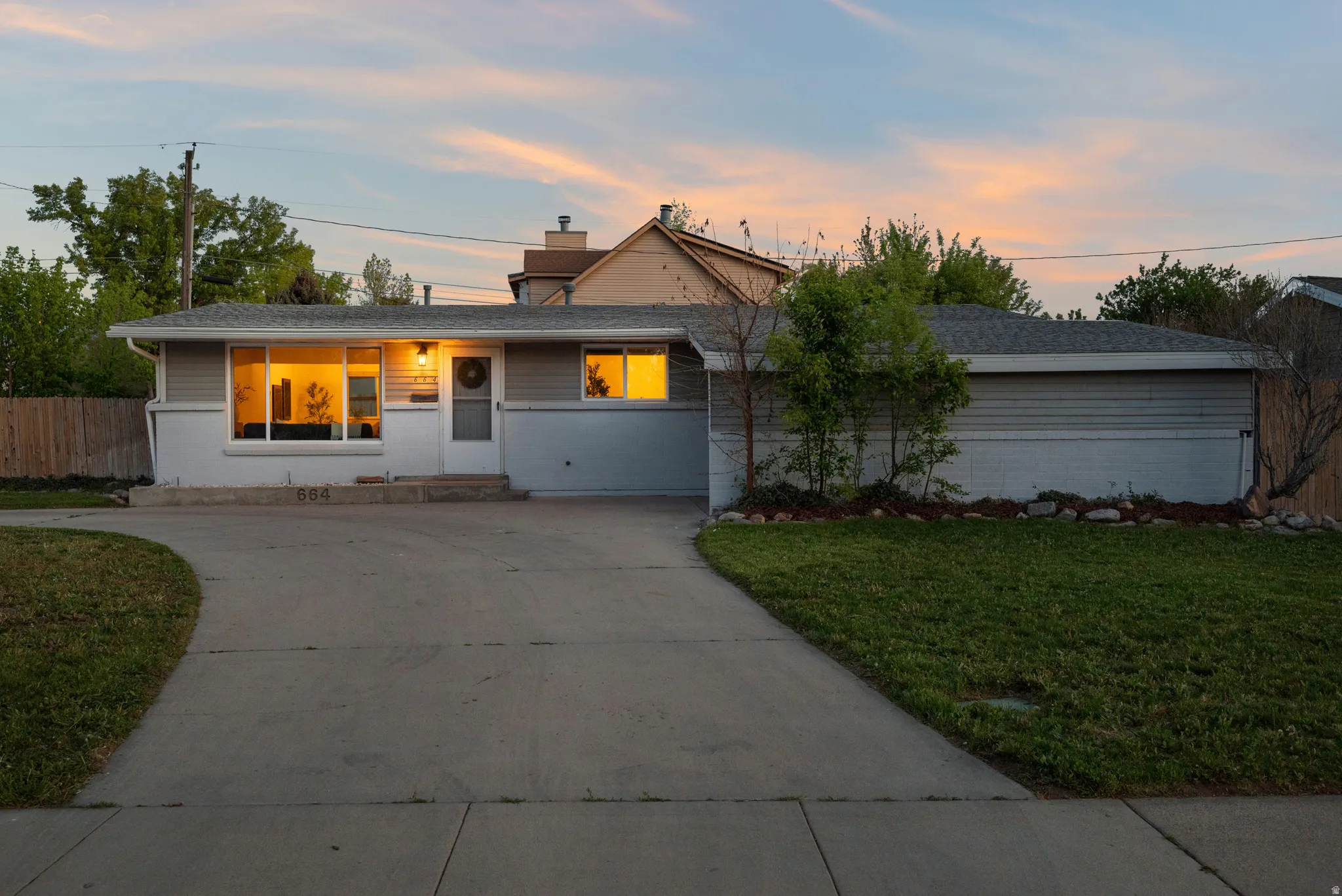 Ranch-style home featuring concrete driveway