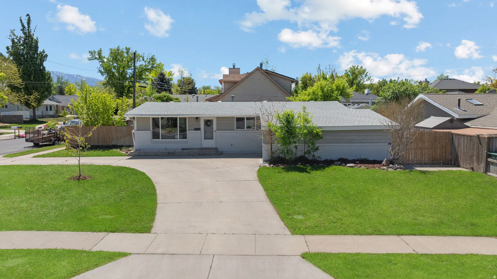 View of front of home featuring covered porch, concrete driveway, and a residential view