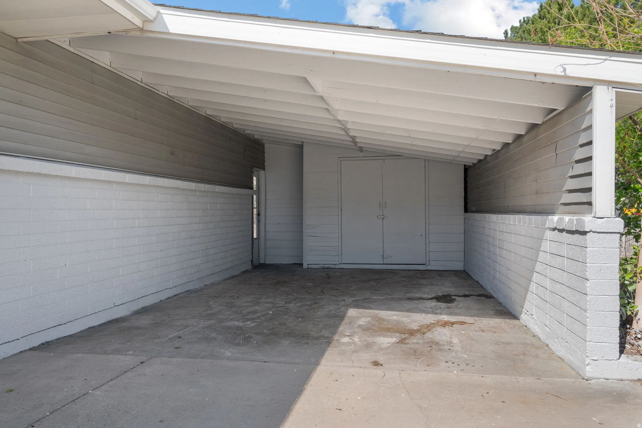 View of parking with a carport