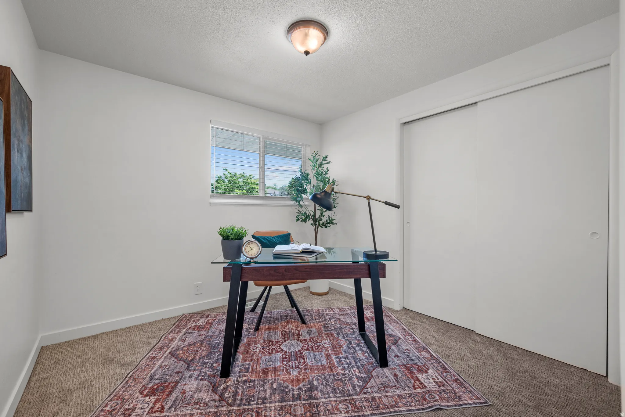 Office featuring light colored carpet and baseboards
