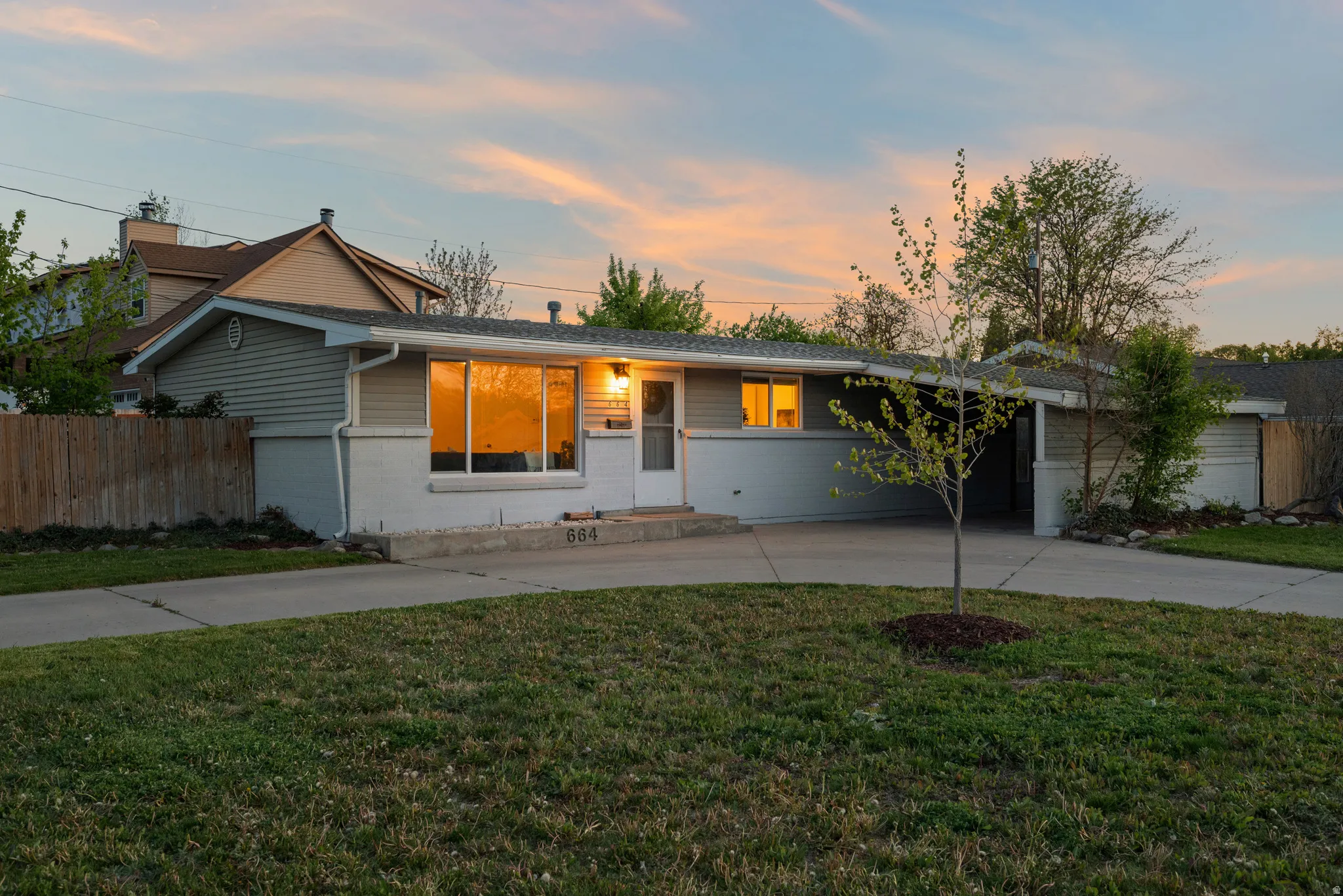 Single story home with curved driveway