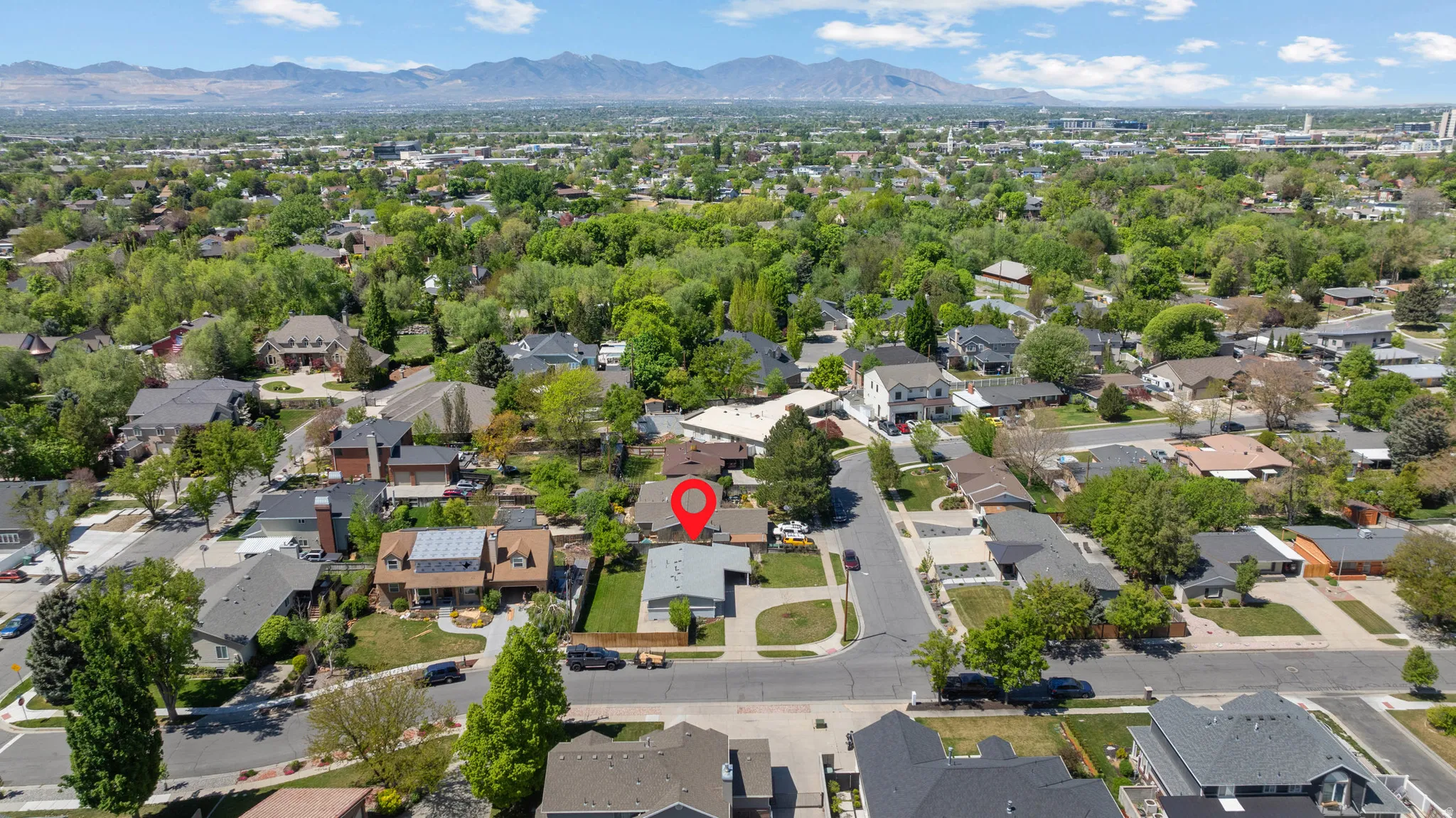 Aerial perspective of suburban area with a mountainous background