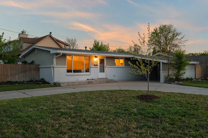 Single story home with curved driveway