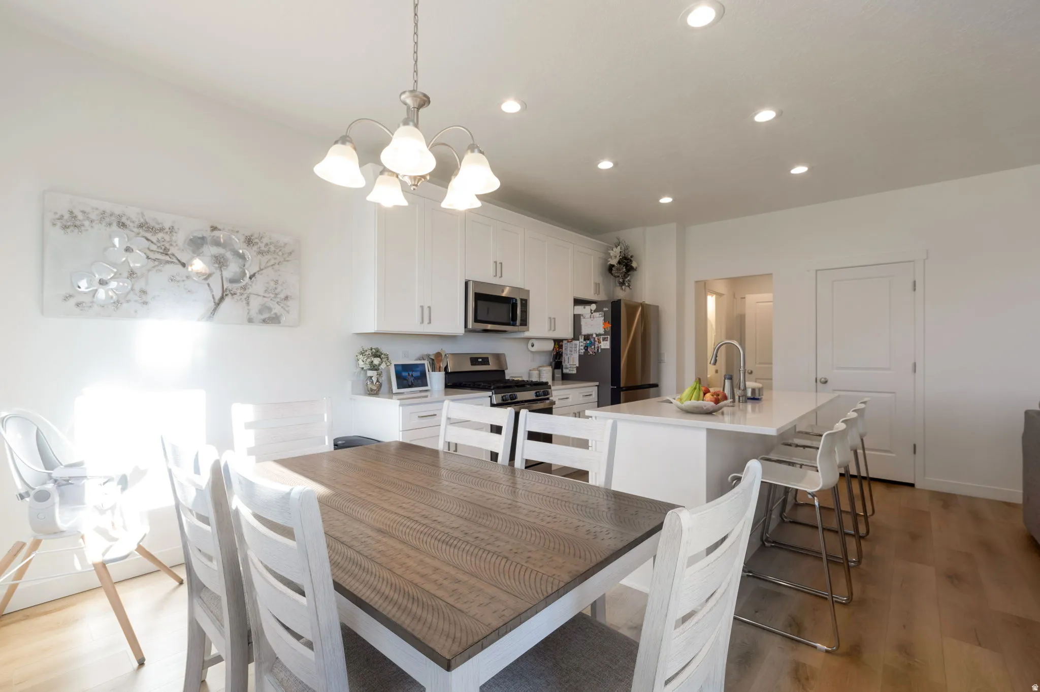 Dining space featuring light wood-type flooring and a chandelier