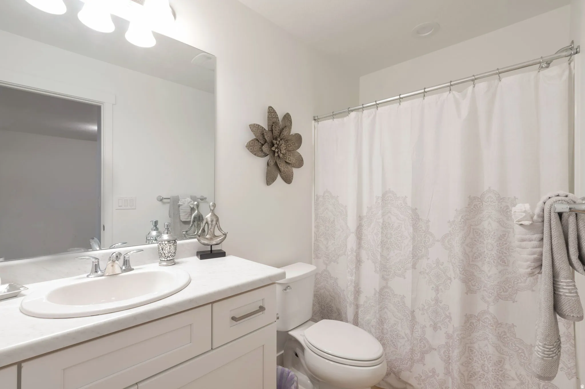 Bathroom with vanity and a shower with shower curtain