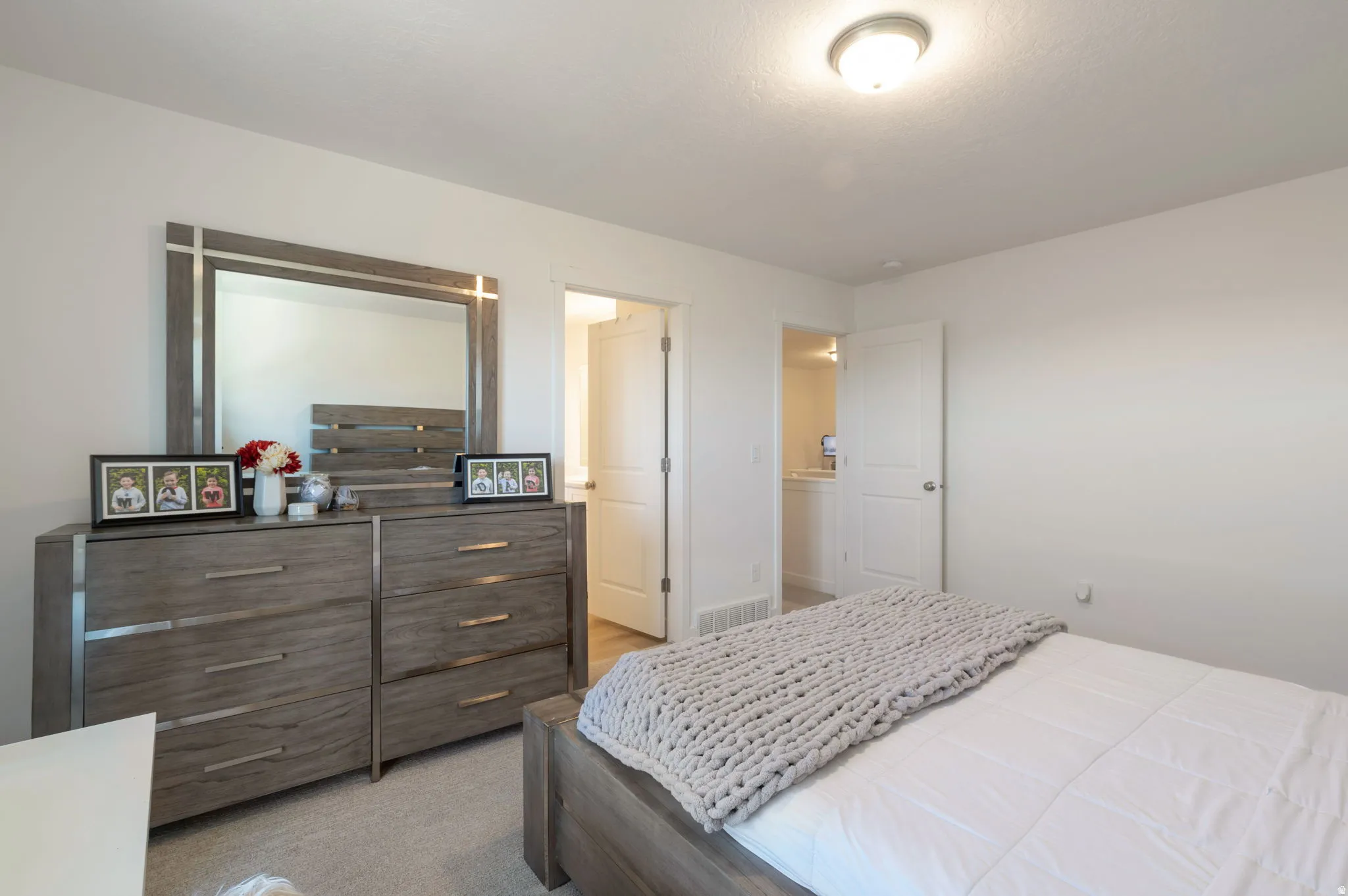 Bedroom featuring light colored carpet