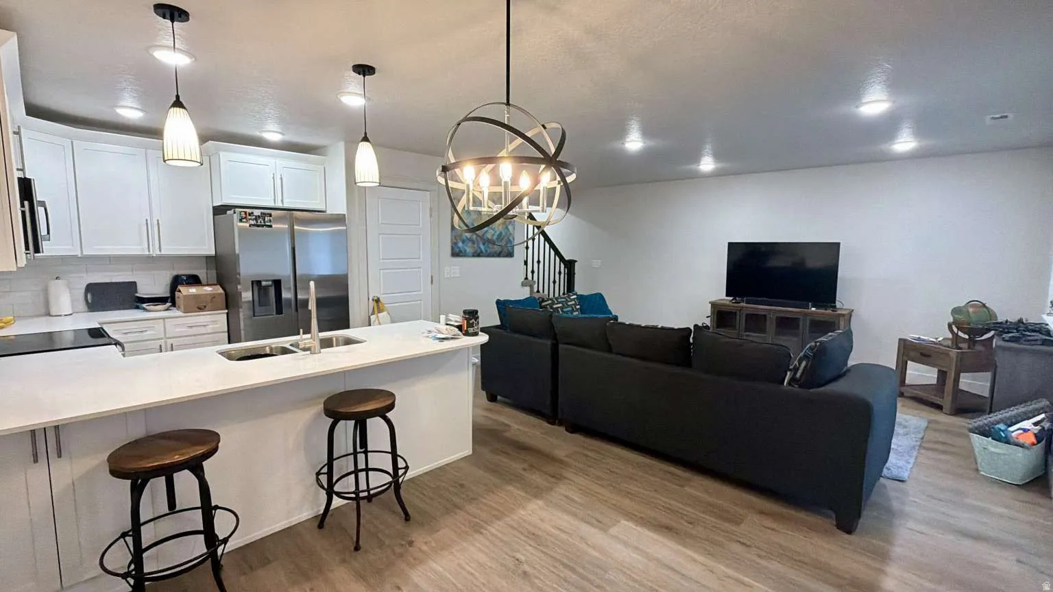 Open-concept living space featuring wood-finish flooring throughout