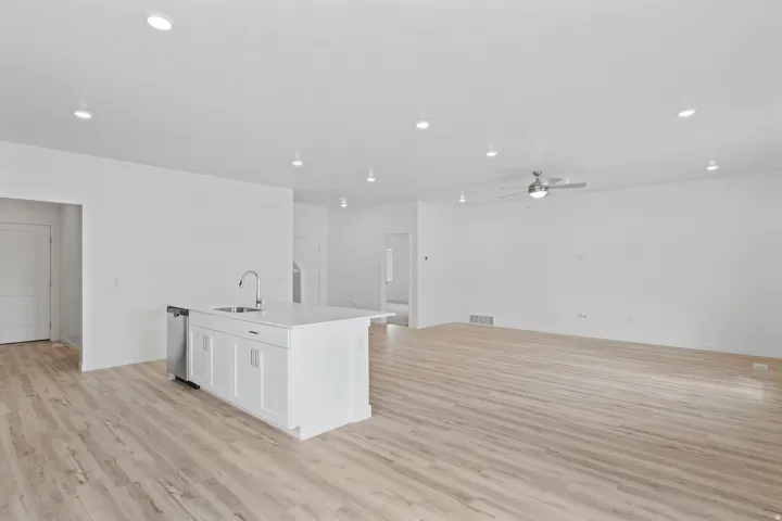Open-concept living space with light wood-finish flooring