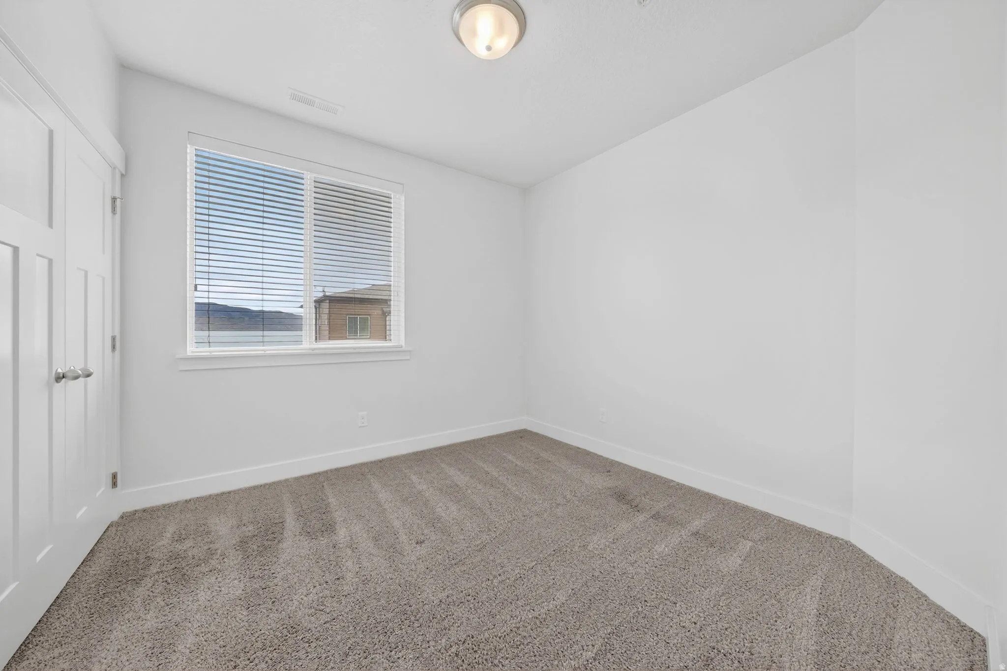 Unfurnished bedroom featuring carpet floors and a closet