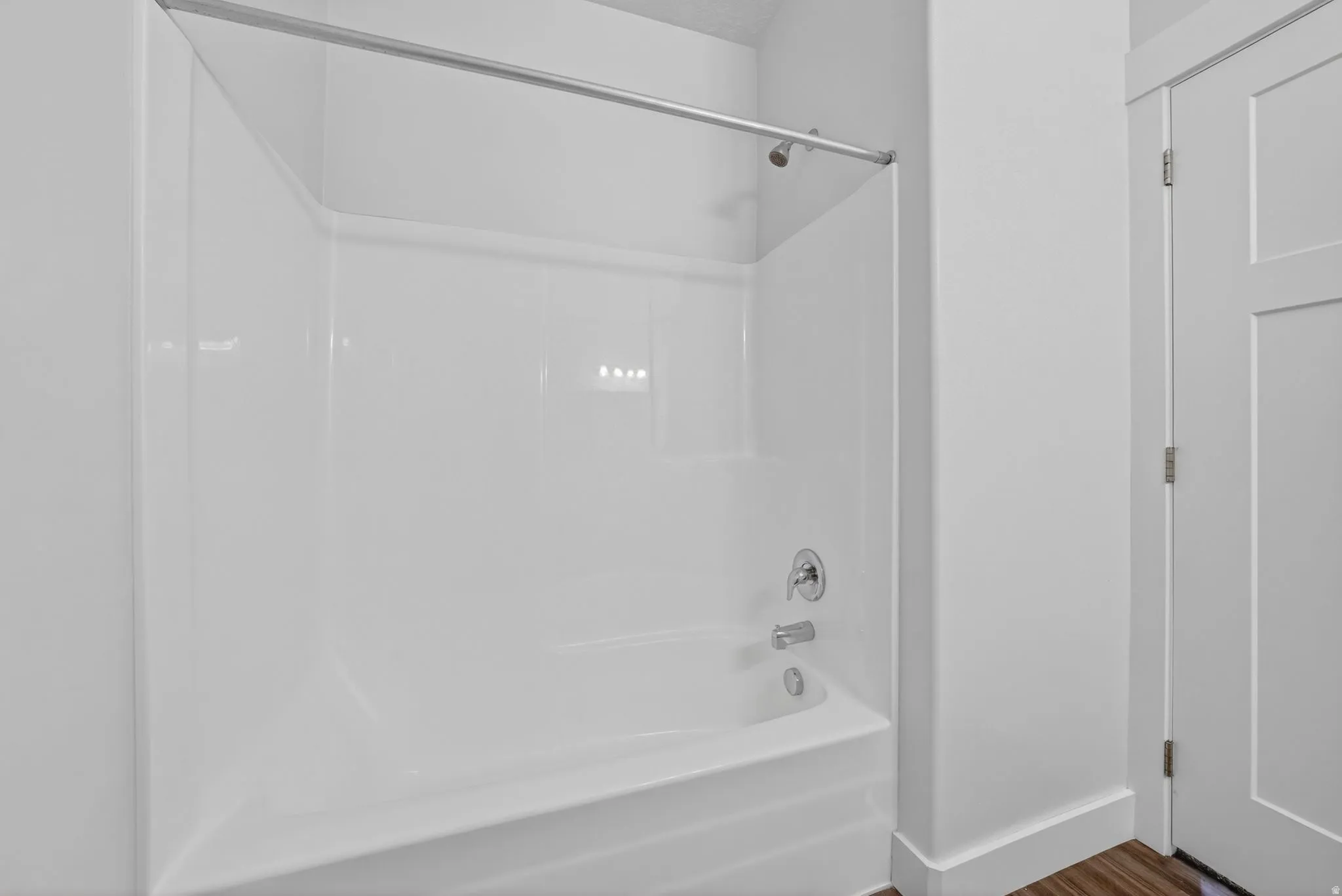 Full bathroom featuring shower / bath combination and dark wood-style flooring