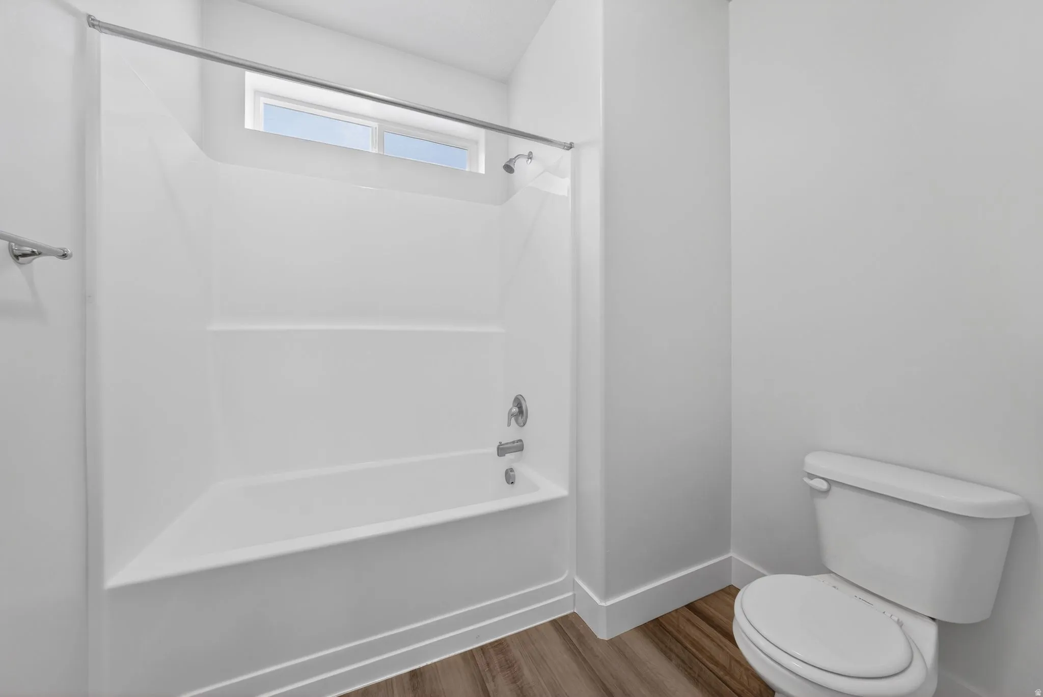 Full bathroom with tub / shower combination and light wood finished floors