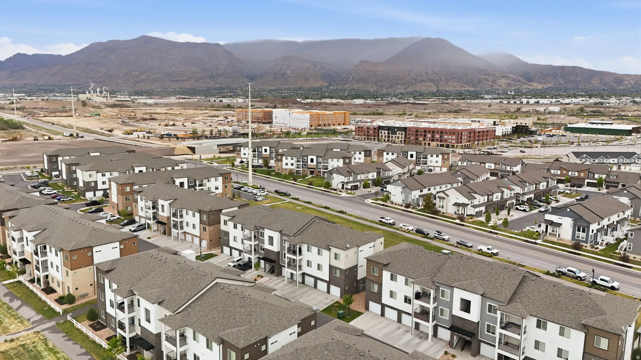 Aerial overview of property's location featuring a mountainous background and nearby suburban area