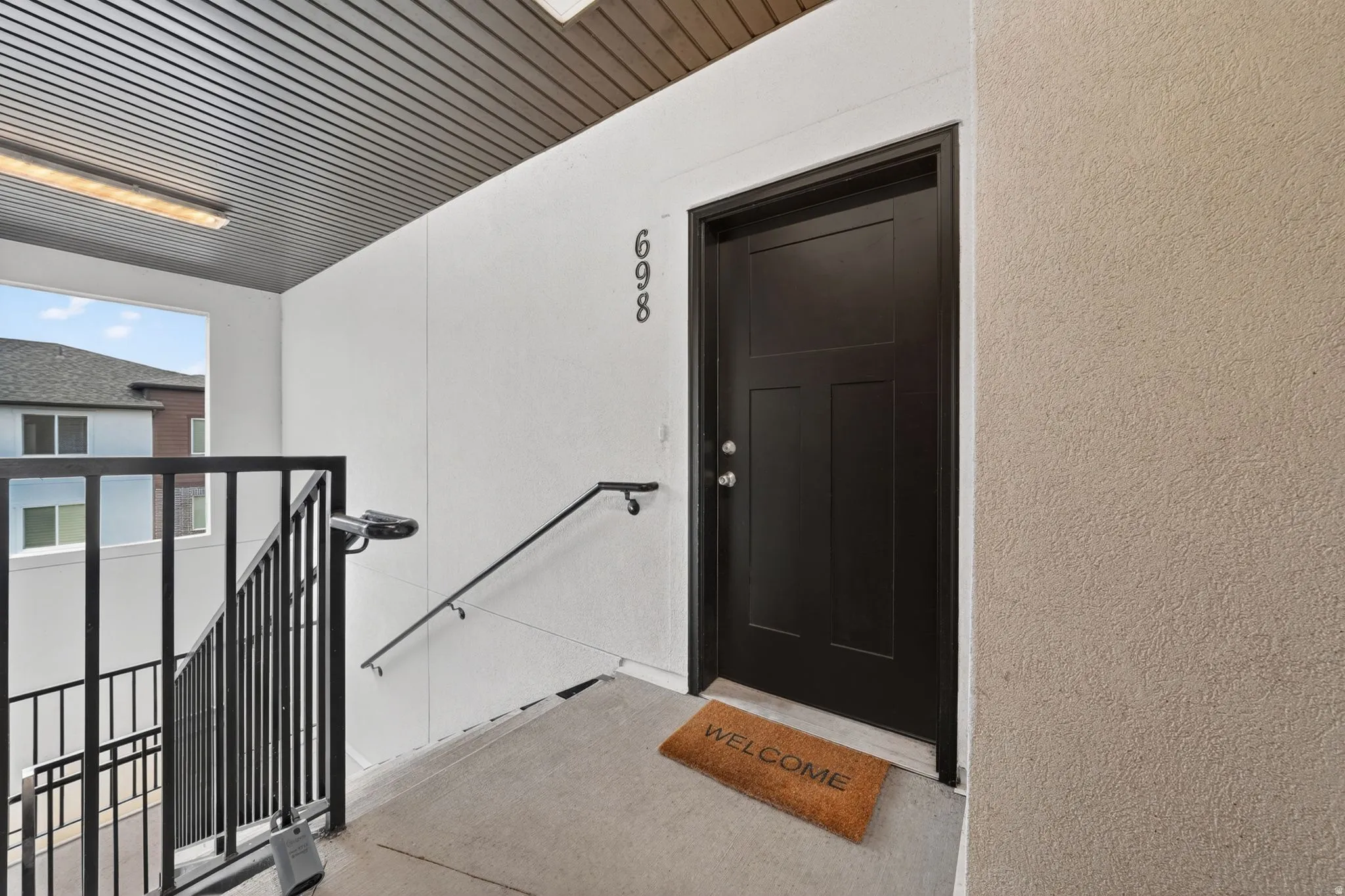 View of exterior entry with stucco siding