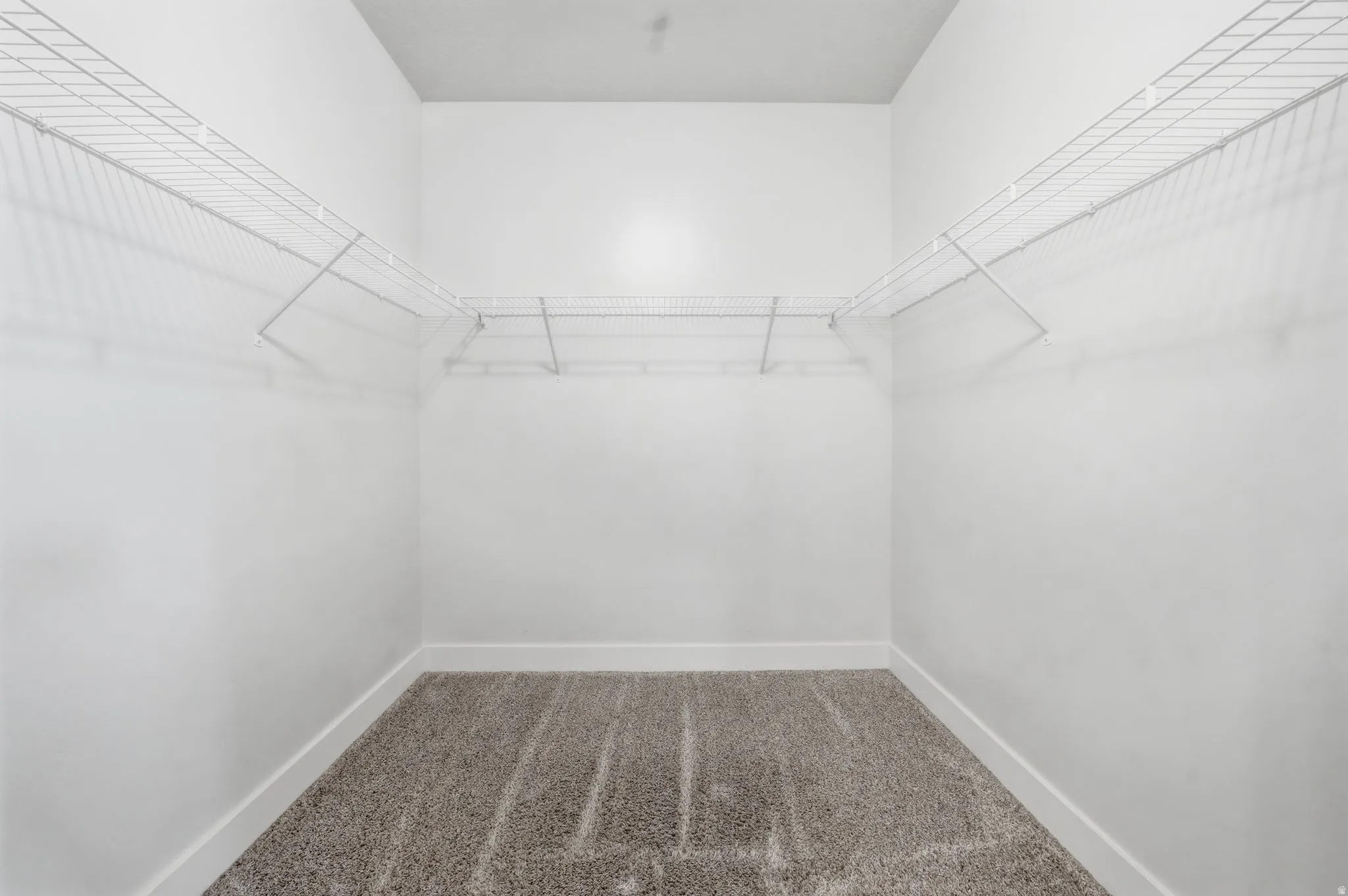 Walk in closet with dark carpet