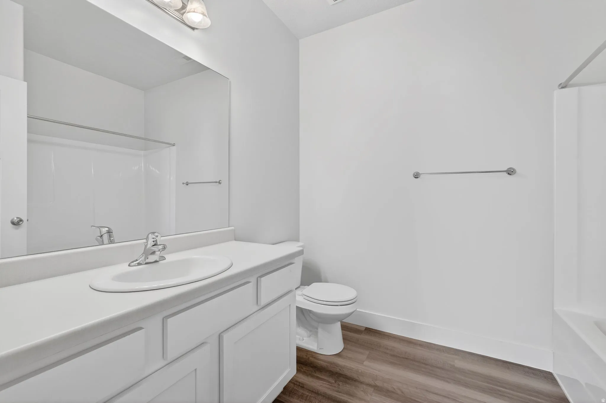 Full bath with vanity, dark wood-type flooring, and bathing tub / shower combination