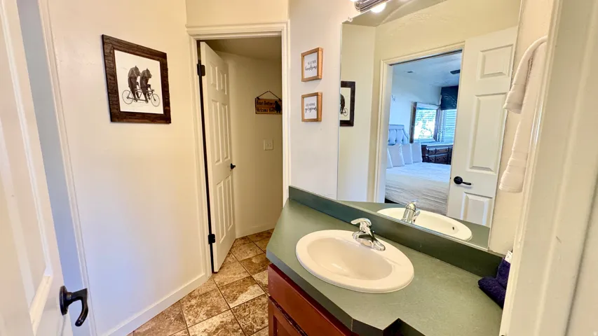 Ensuite bathroom featuring vanity and baseboards