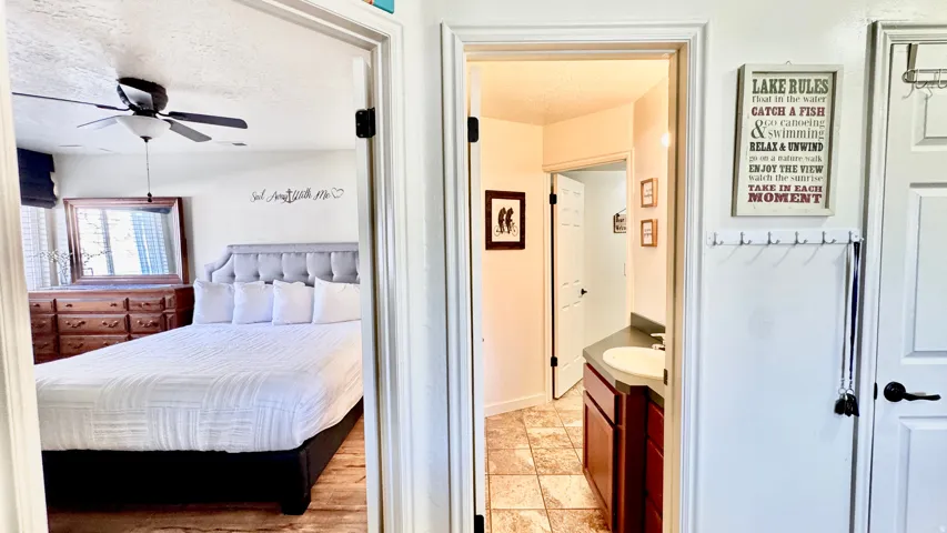 Bedroom with a textured ceiling and ceiling fan