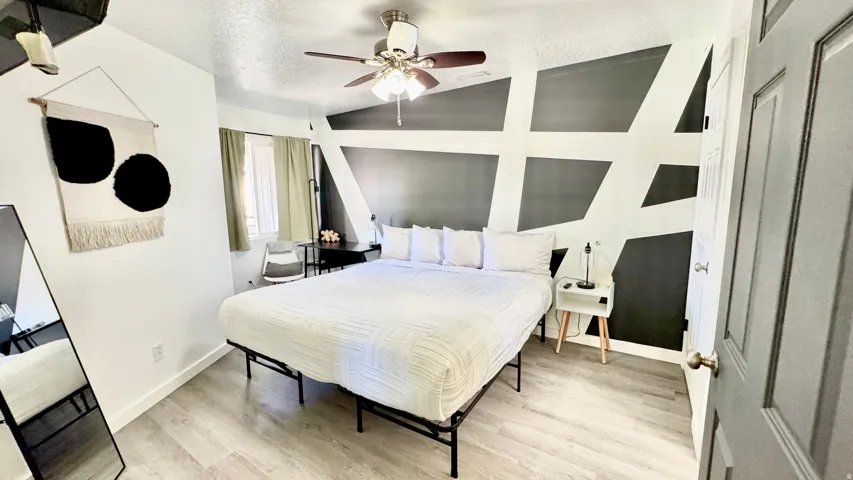 Bedroom with light wood-type flooring and ceiling fan