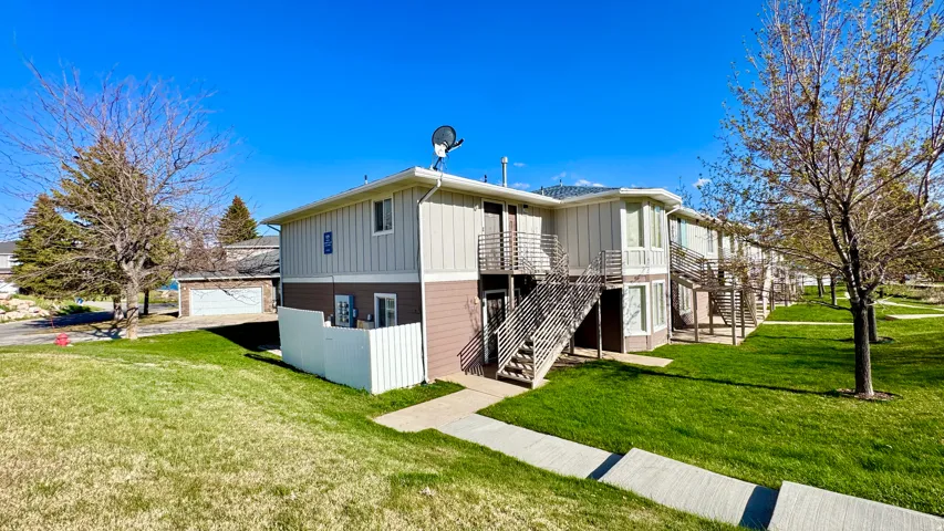 View of side of property featuring a yard, a garage, and board and batten siding