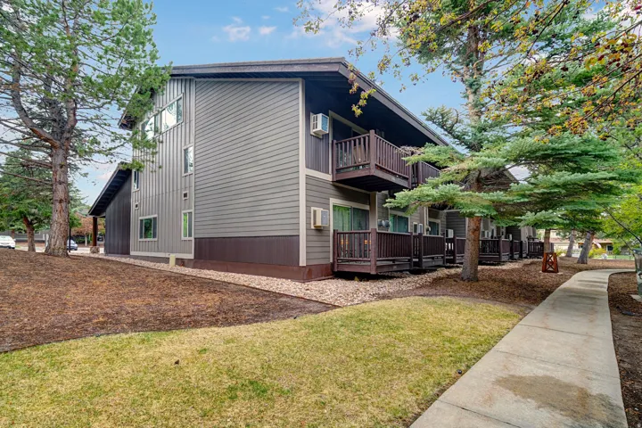 View of side of home with a yard