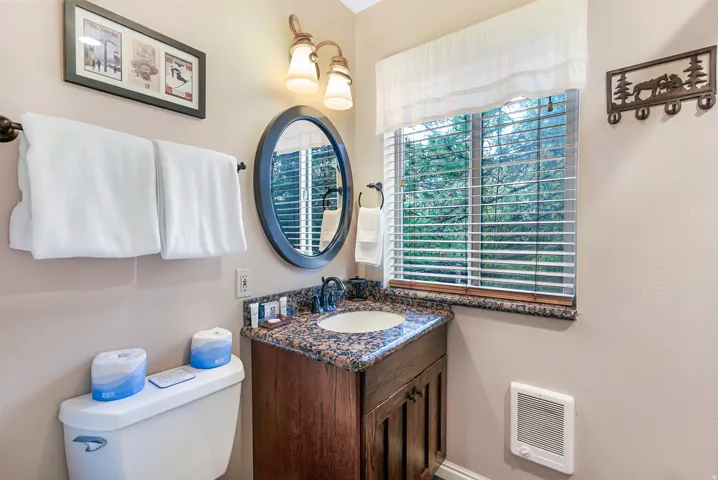 Half bathroom with vanity and heating unit