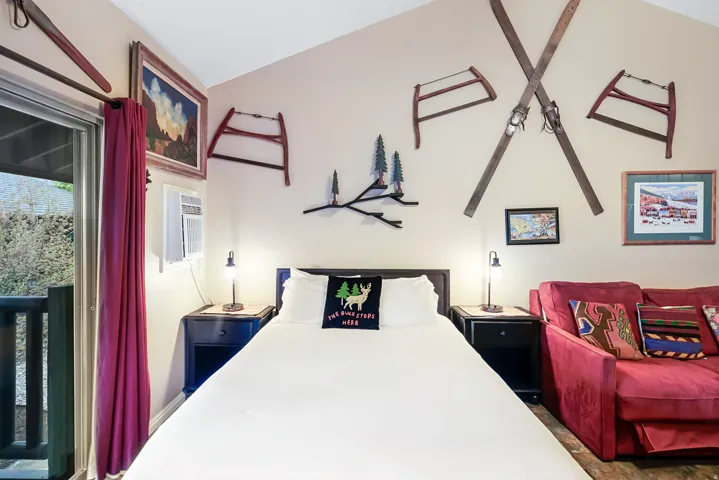 Bedroom featuring a wall mounted air conditioner and access to outside