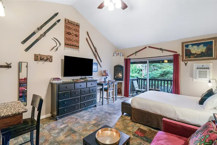 Bedroom featuring access to exterior, lofted ceiling, and ceiling fan