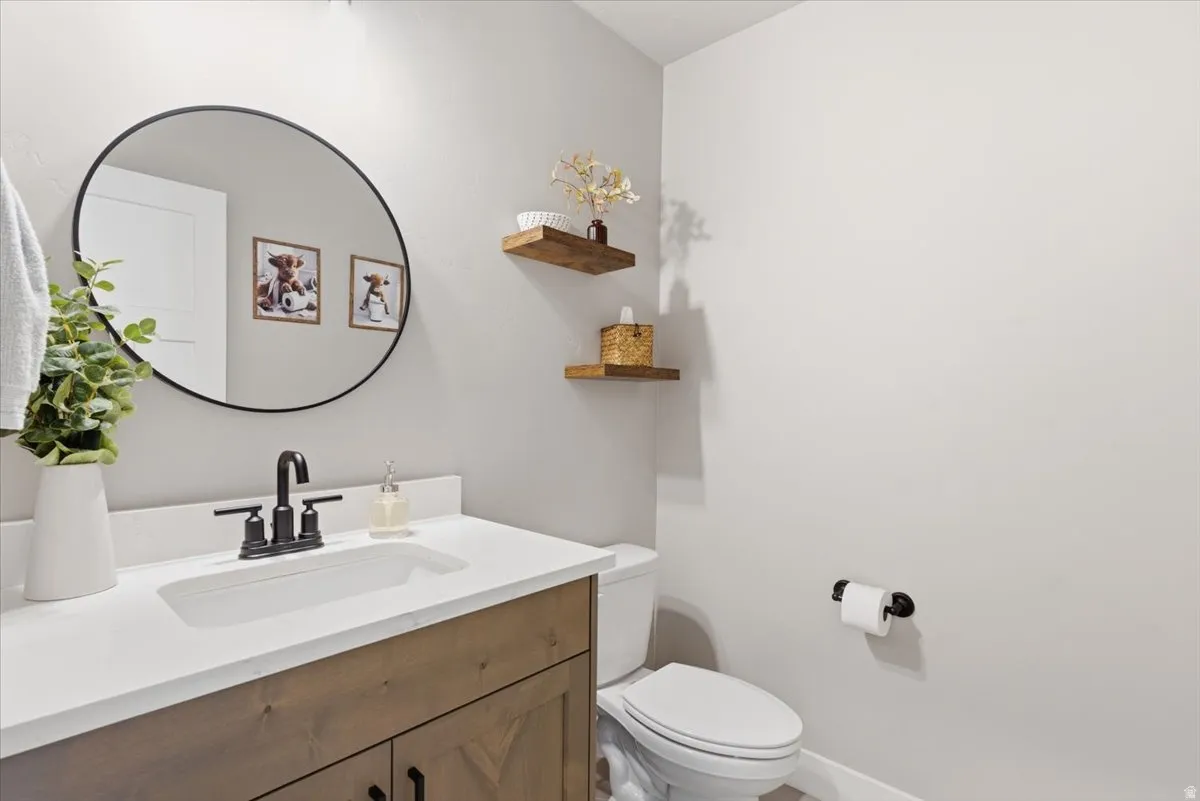Half bath featuring vanity and toilet