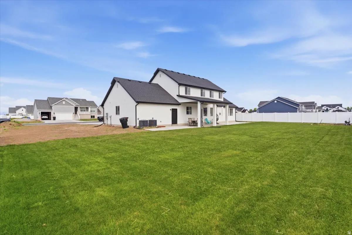 Back of property featuring a patio area and a residential view