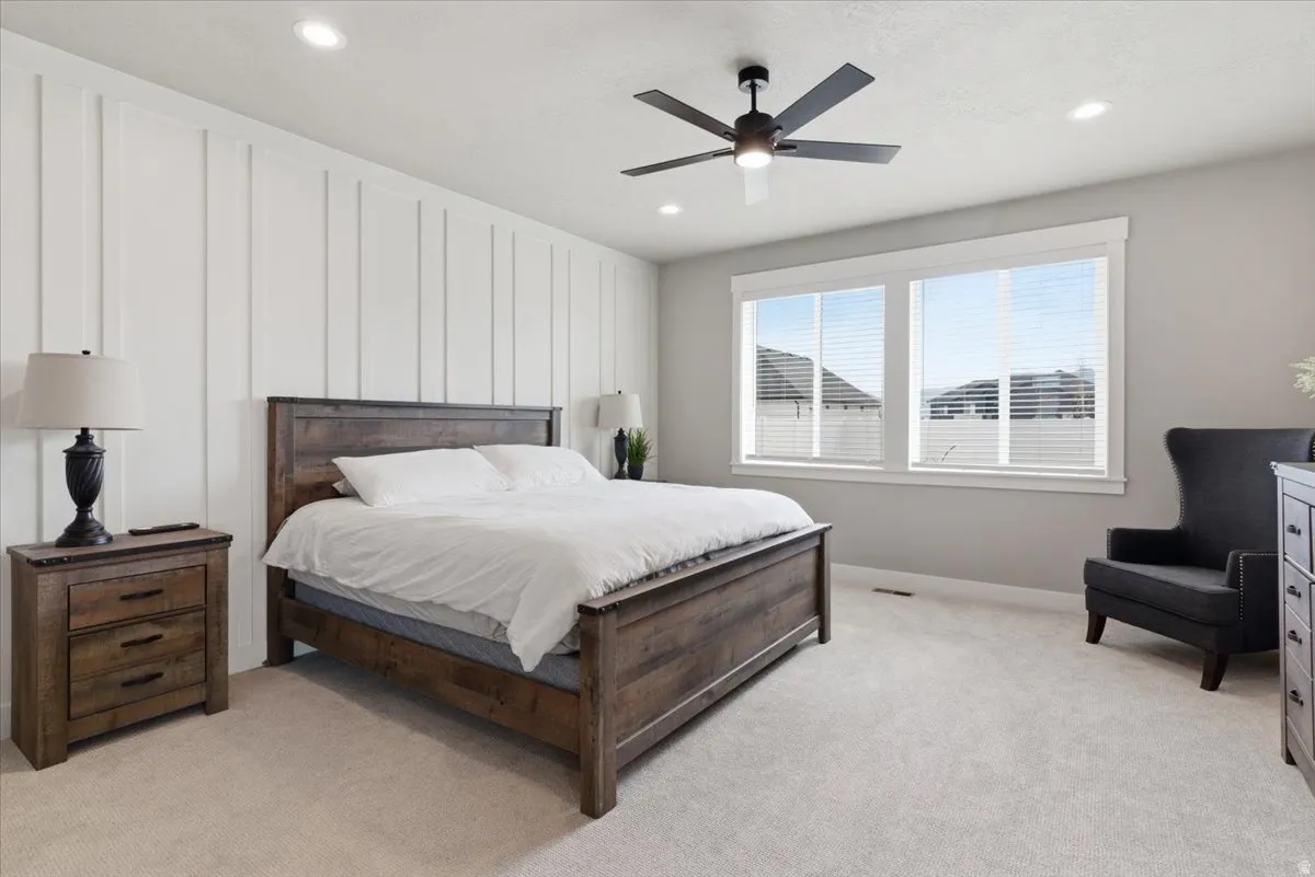 Bedroom featuring light carpet, a ceiling fan, and recessed lighting