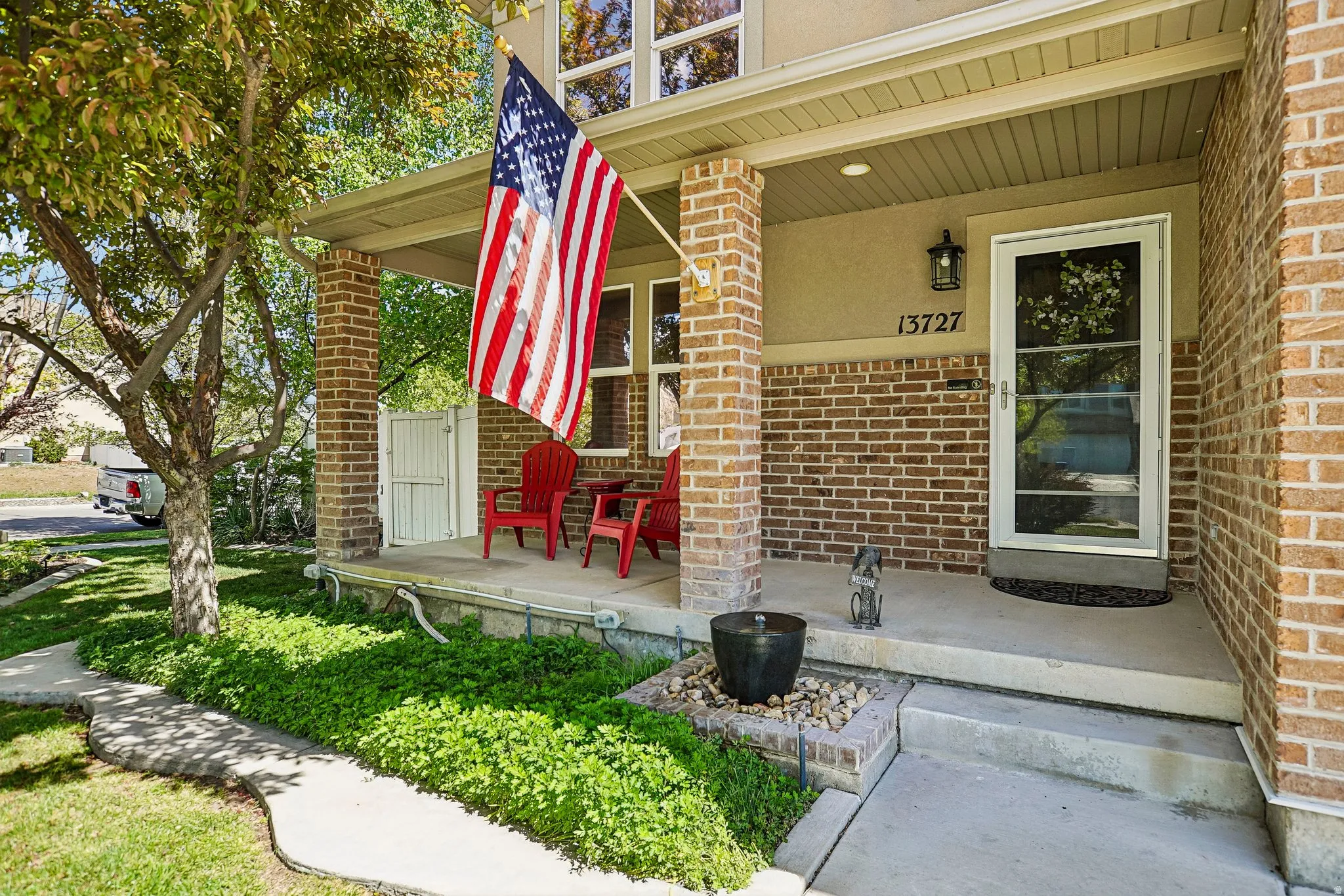 View of exterior entry featuring a porch and brick siding