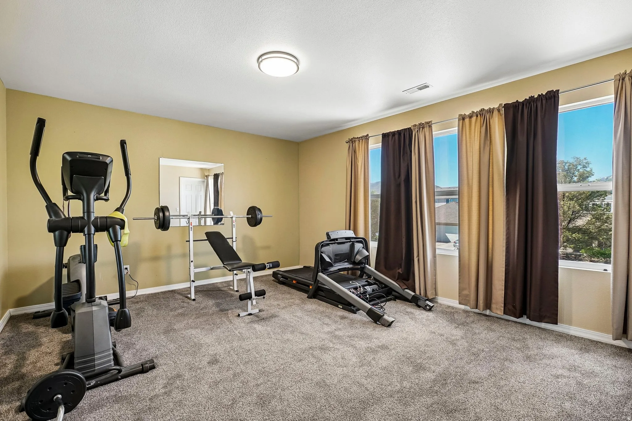 Exercise area featuring baseboards and carpet