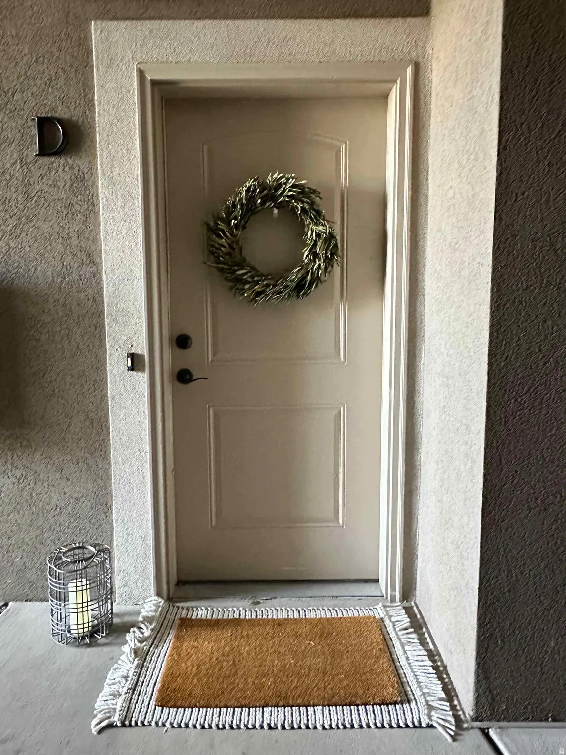 Entrance to property with stucco siding